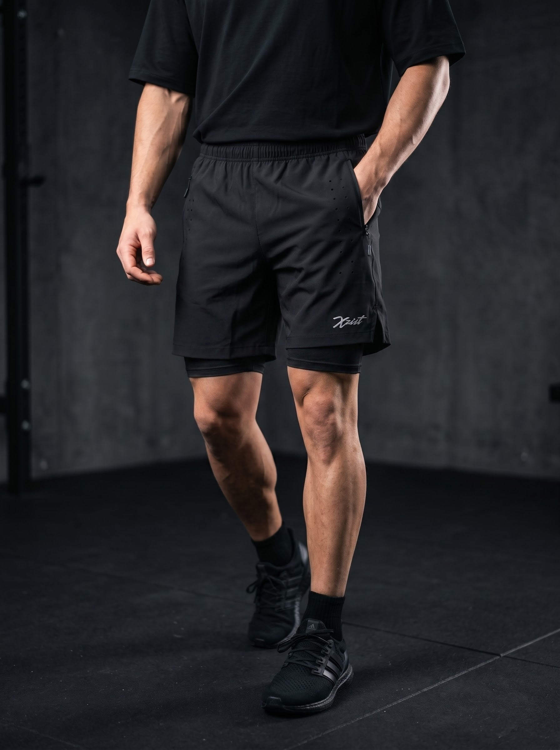 XZIZT gym shorts in black, model walking #Color_Black