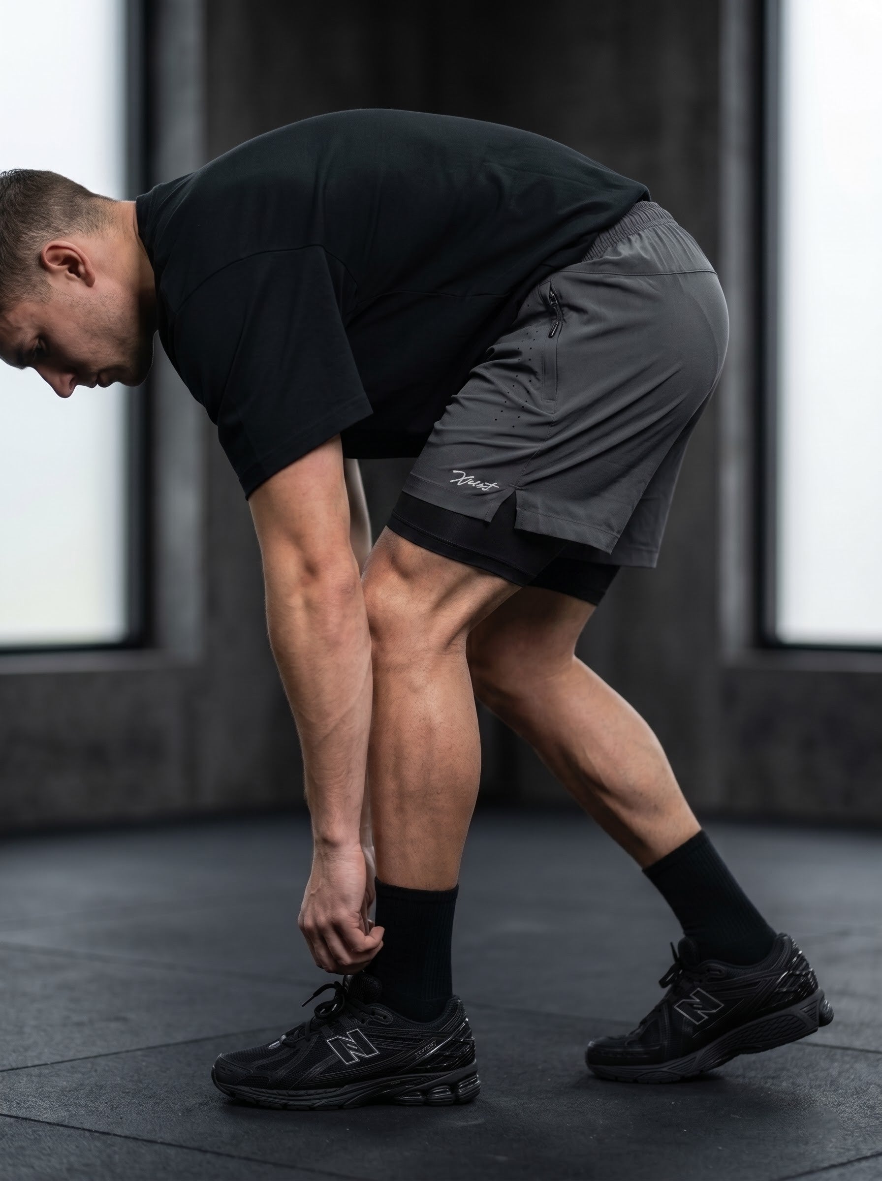 XZIZT gym shorts in dark grey, model posing #Color_Grey