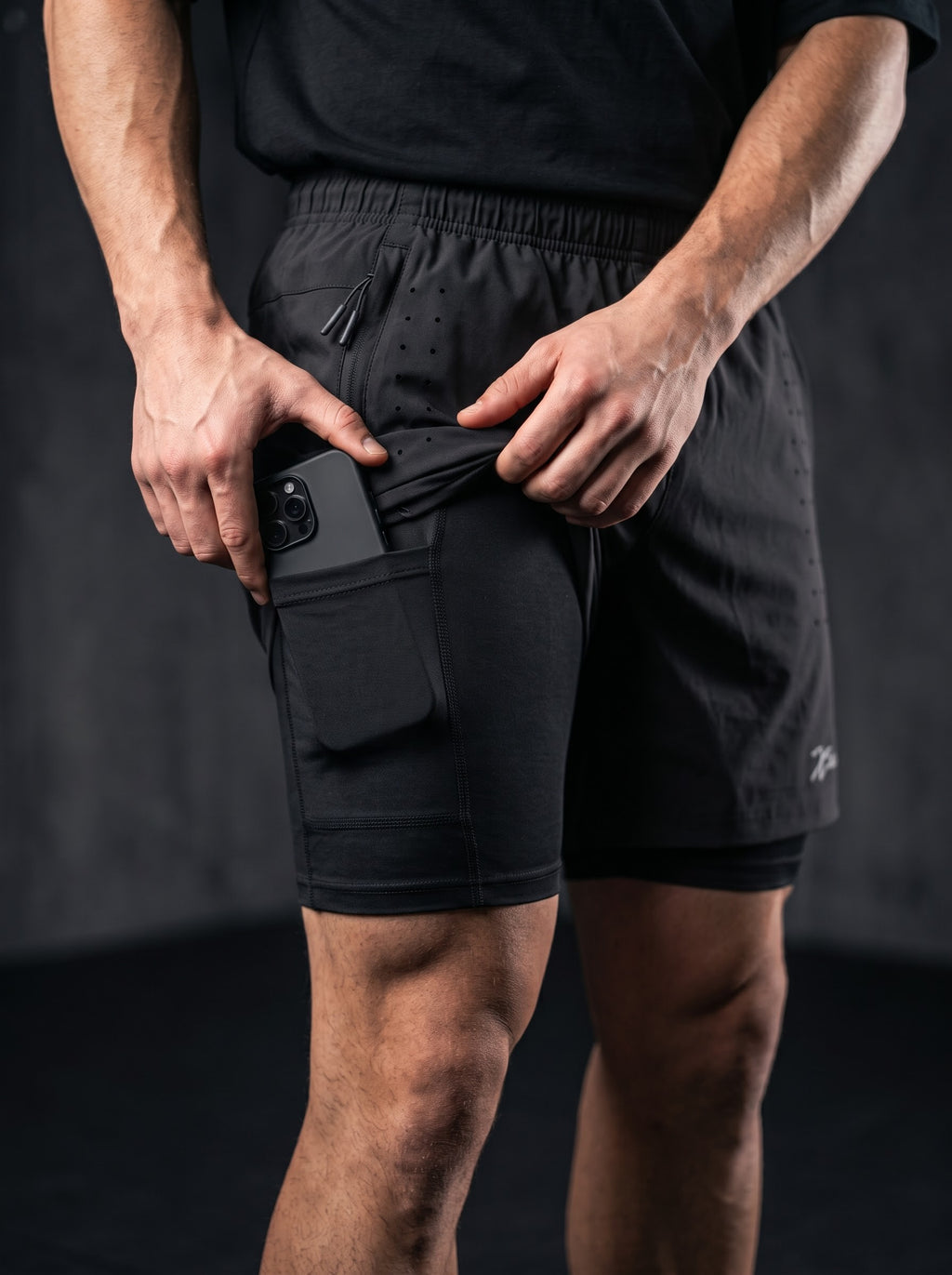 XZIZT gym shorts in black, logo detail close-up #Color_Black