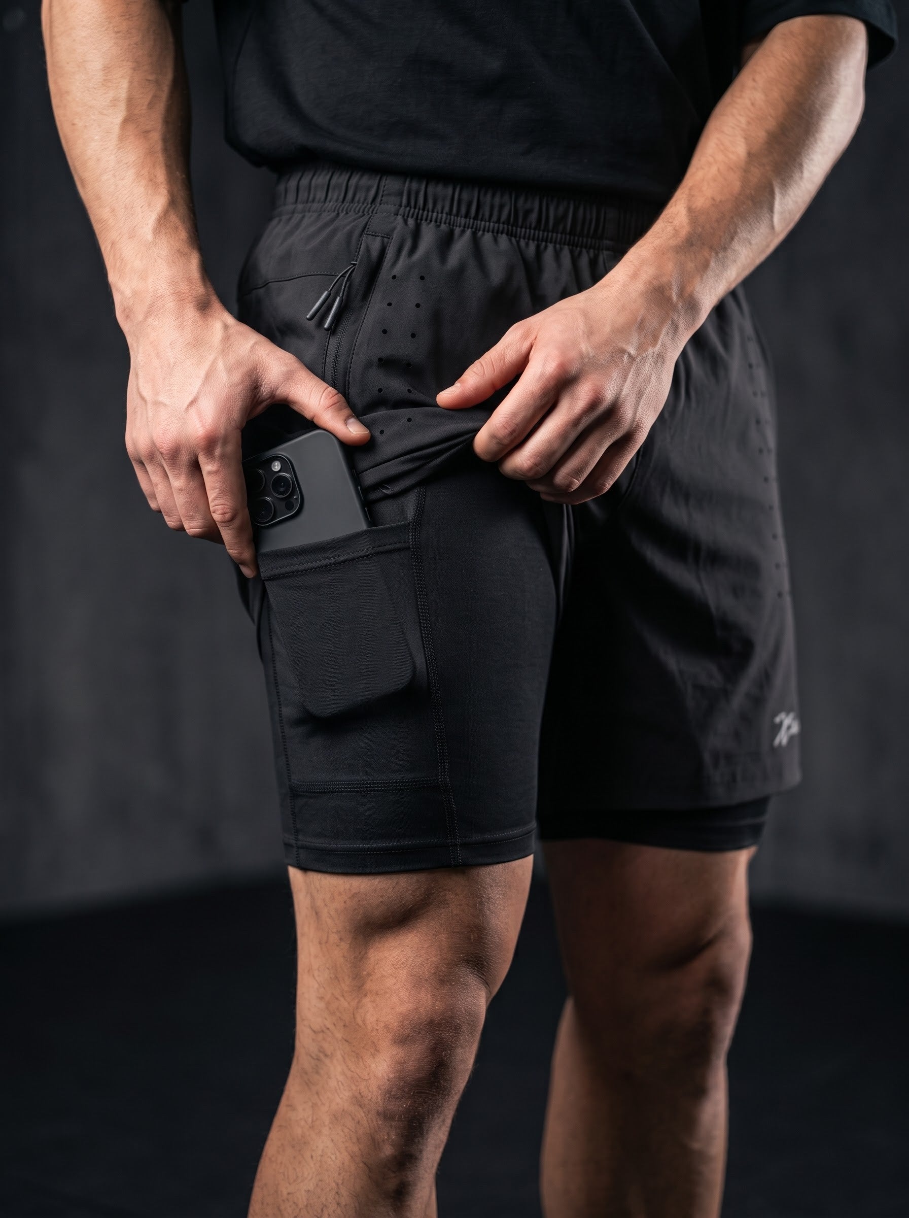 XZIZT gym shorts in black, logo detail close-up #Color_Black